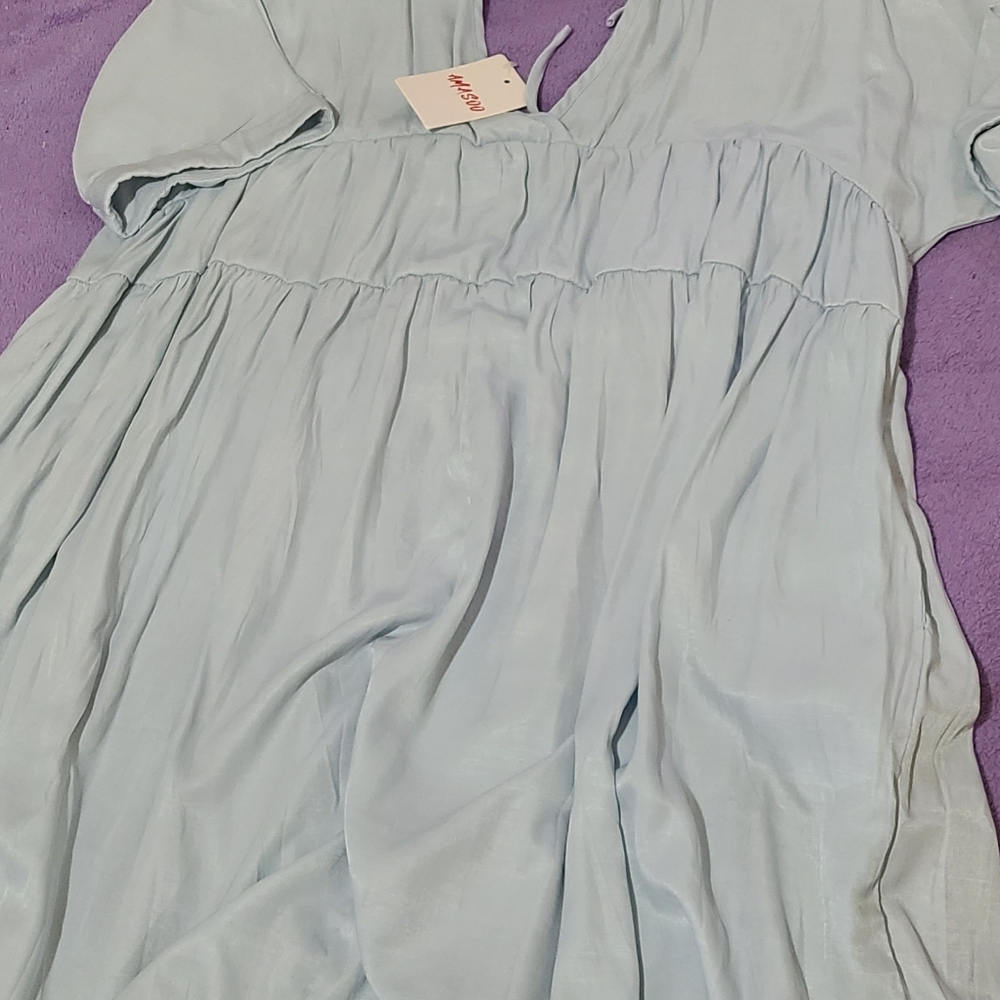 Baby blue short sleeve, lower cut back and front, pocketed dress.